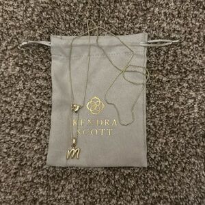 Kendra Scott gold necklace with “m” charm